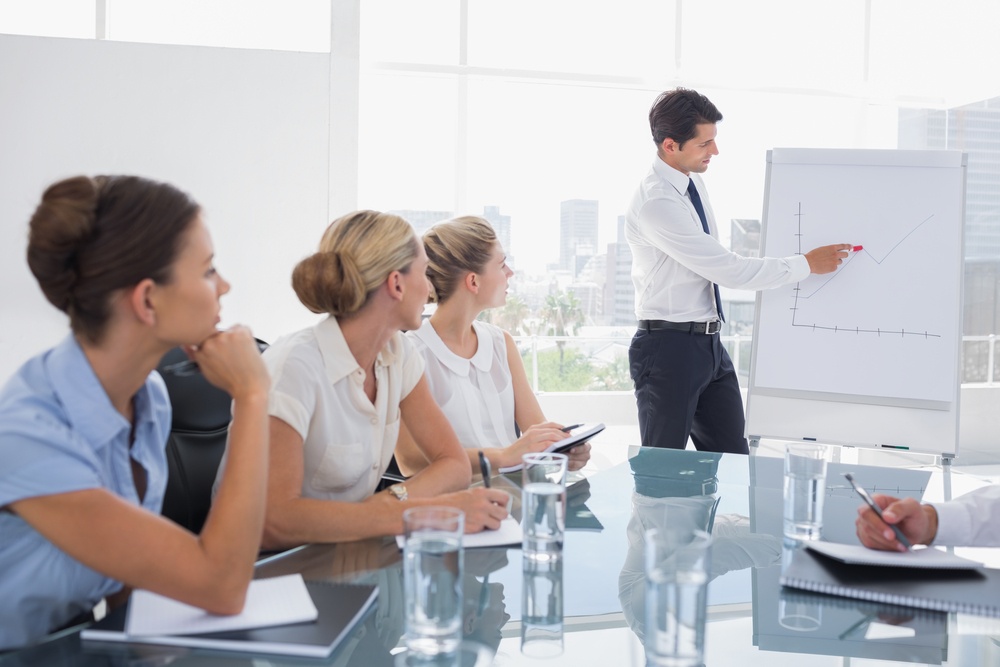 Businessman pointing at a growing chart during a meeting